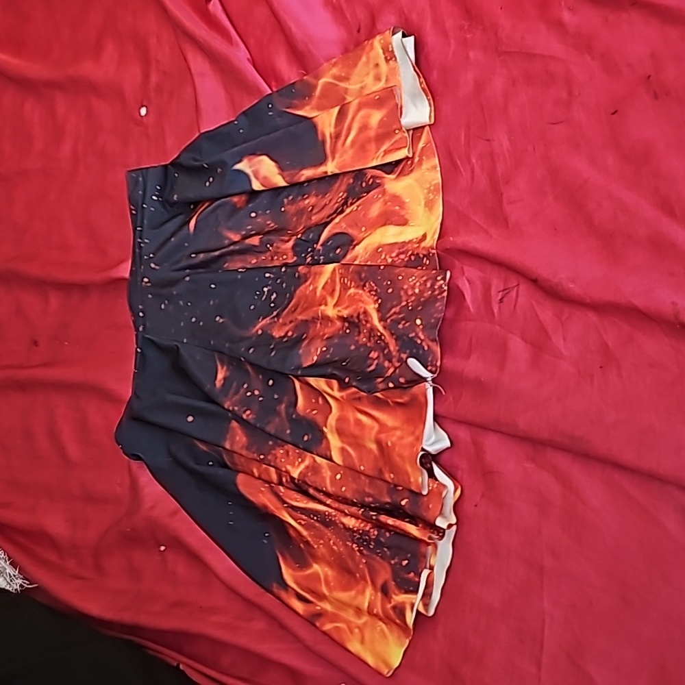 Never worn skirt with pleats and fire on it.